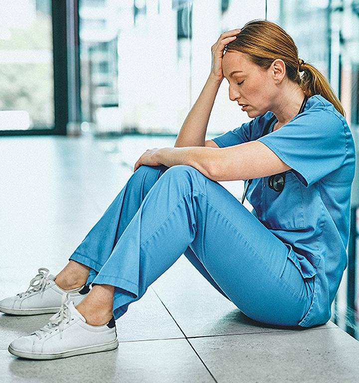 Illustration of a figure under stress, highlighting moral injury in healthcare.